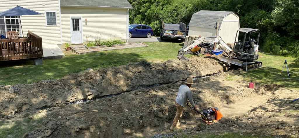 Excavating a lawn trench for drainage