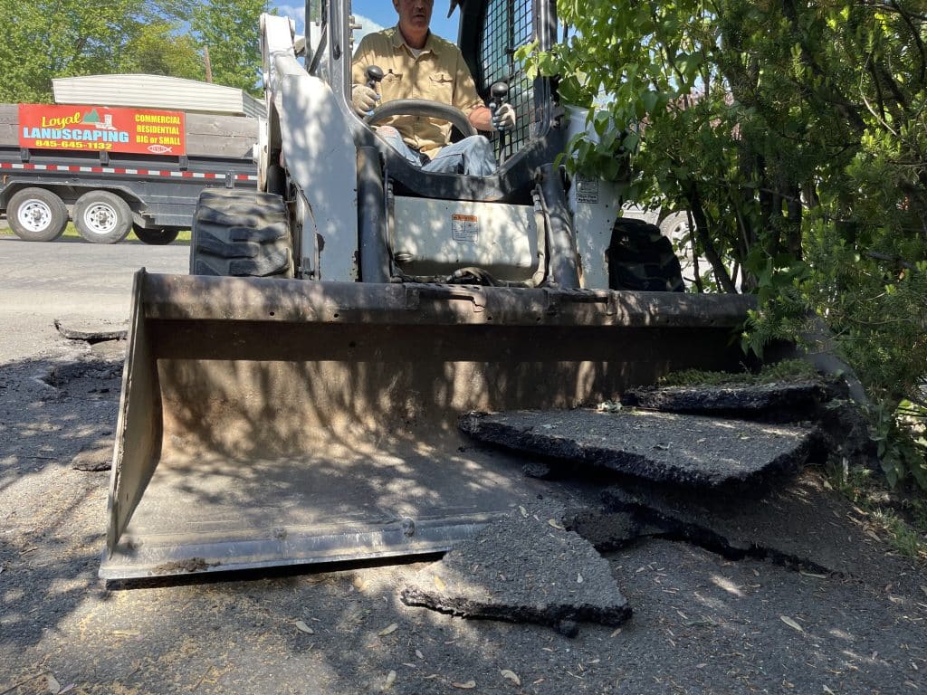 Removing an old asphalt driveway Removing asphalt drivway with skid steer