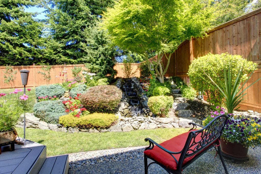 Sitting area with view of beautifully landscaped yard.