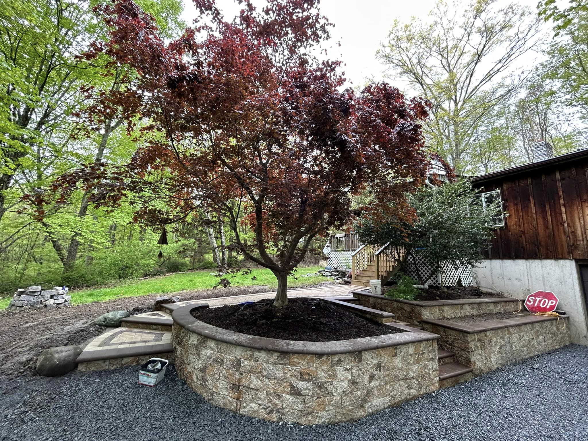 Retaining wall, steps and walkway with landscaping sections