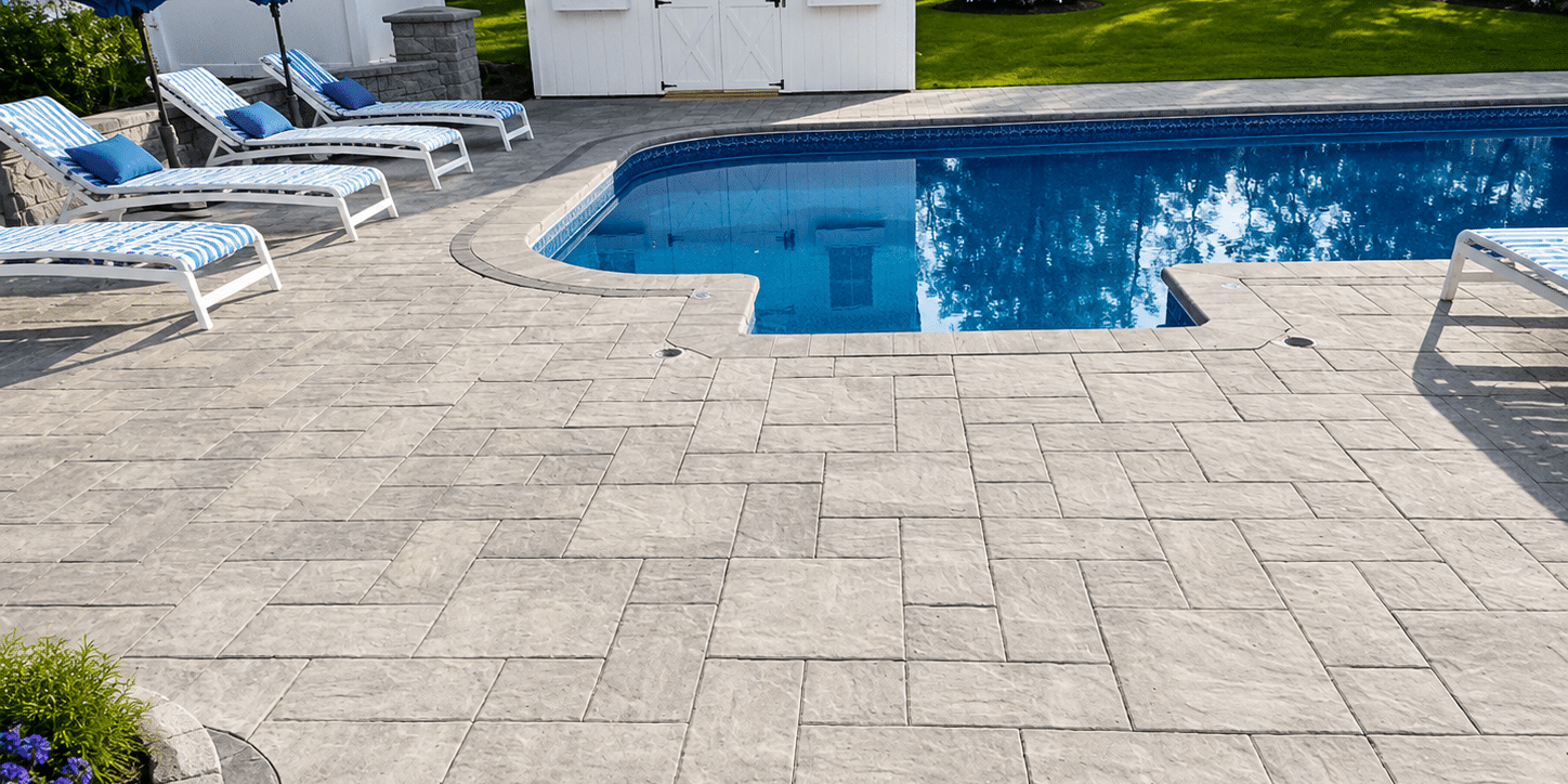 Lounge chairs and blue umbrellas beside a sparkling pool highlight expert Pool Design & Installation Services.