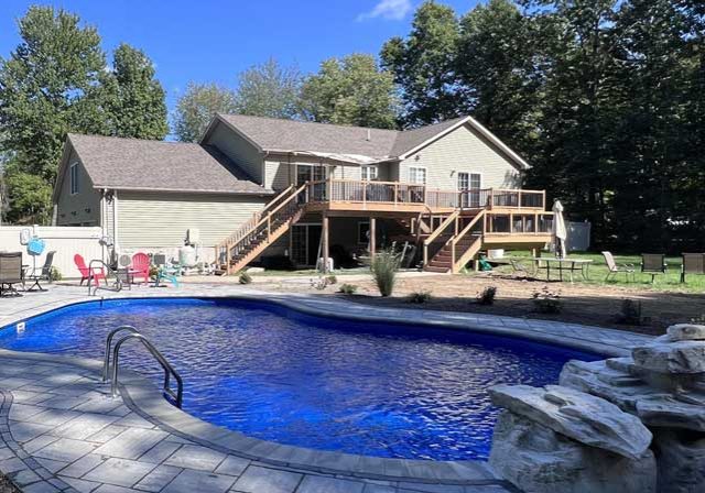 Newly installed pool with paver landscaping