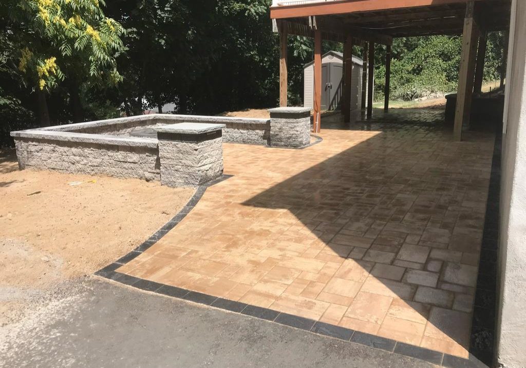 After shot of stone patio, sitting wall and fire pit installation